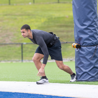 Man preparing to throw a javelin on a track and field field