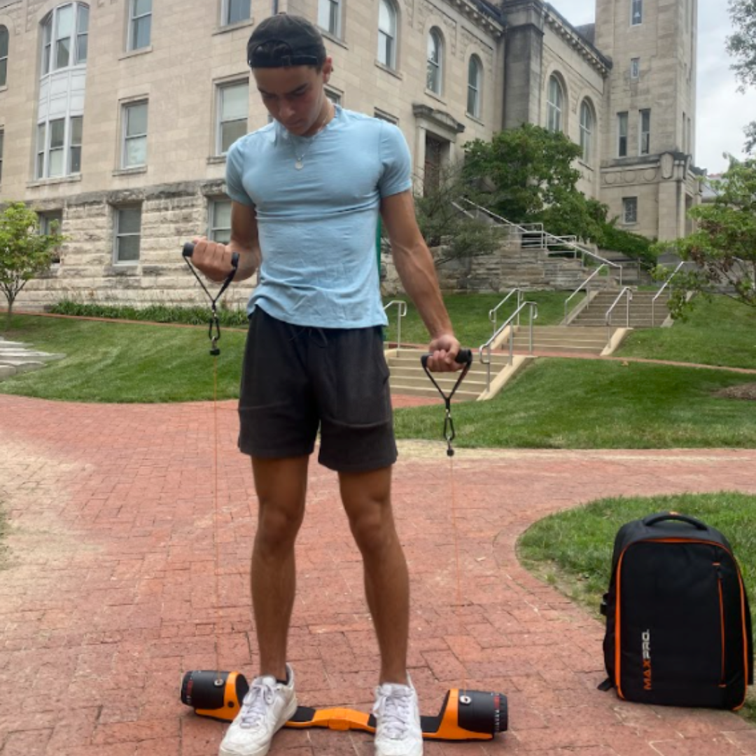Person using a MAXPRO outdoors on a brick path with a building in the background