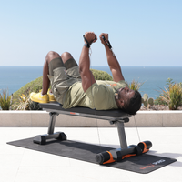 Man exercising on a fitness bench with ocean view