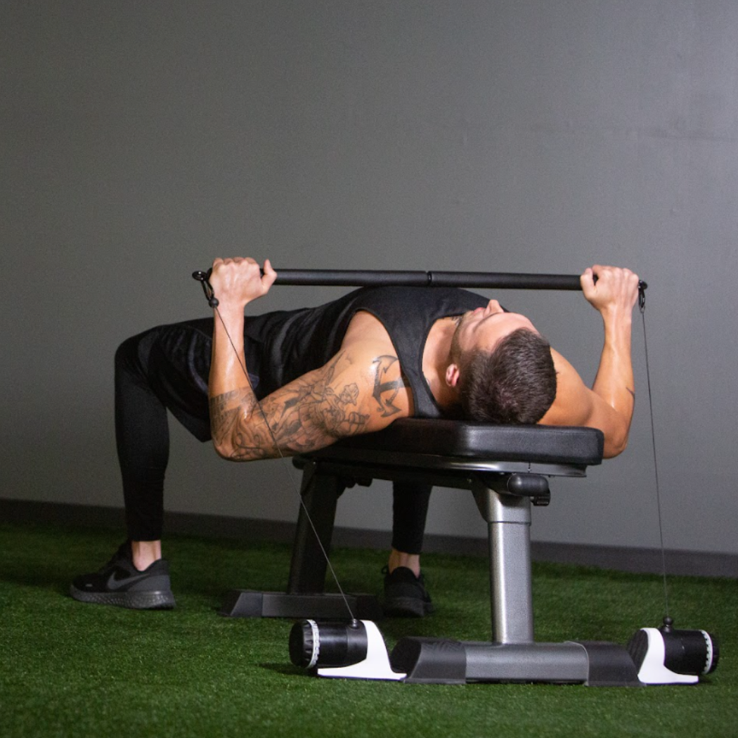 Man using a cable machine, maxpro, in a gym setting