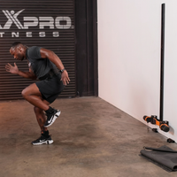 Person exercising in a gym with MAXPRO Fitness branding in the background
