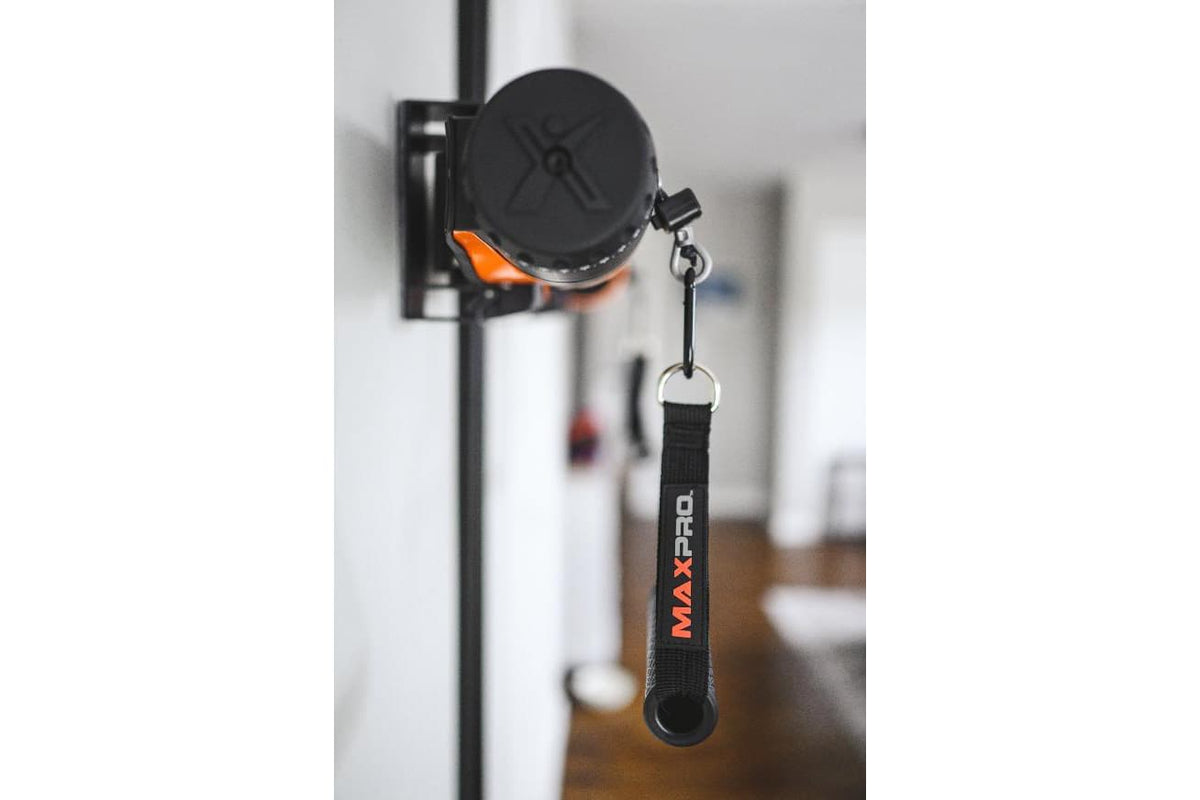Side view of an orange MAXPRO cable trainer mounted on a SlimLine Wall Track, with a black MAXPRO handle hanging from a carabiner.